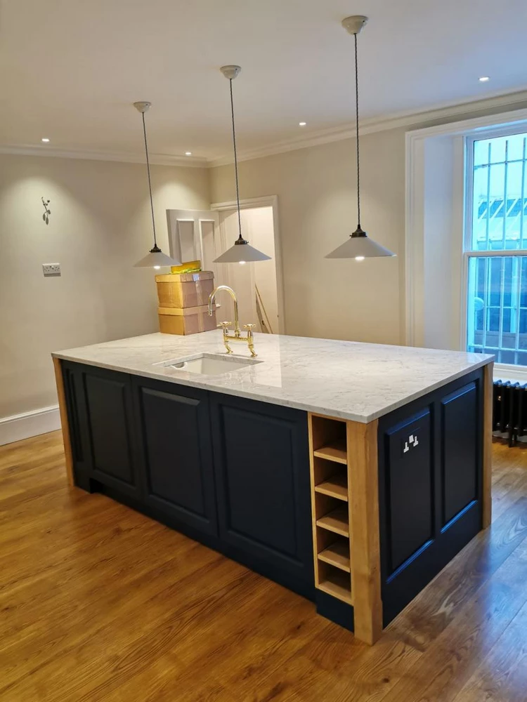 kitchen island with marble top and golden sink