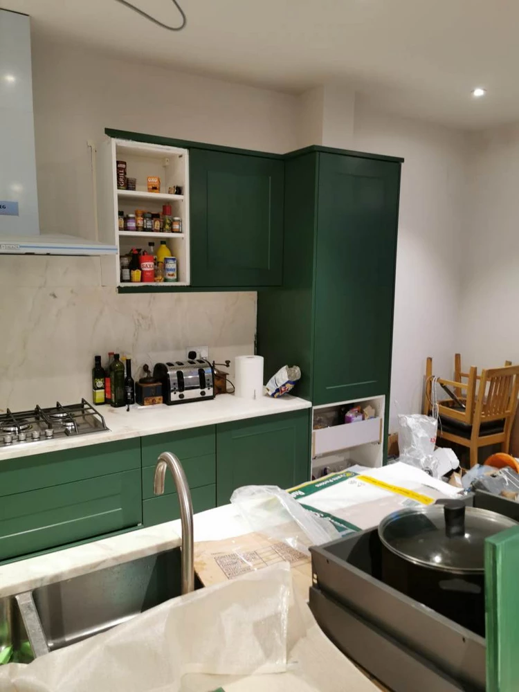 kitchen with green cabinets during renovation
