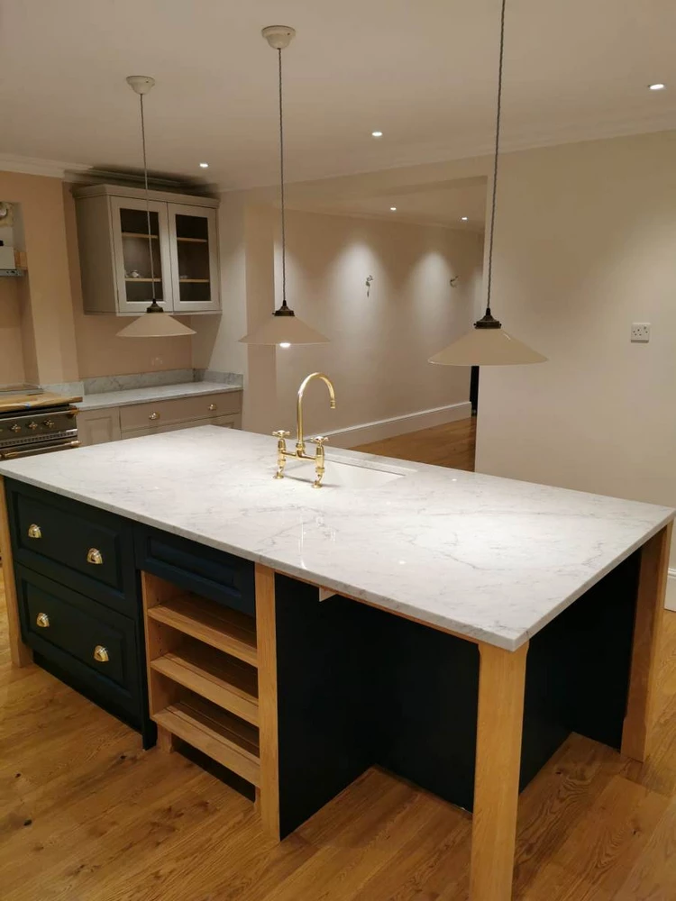 kitchen island with marble top and golden sink
